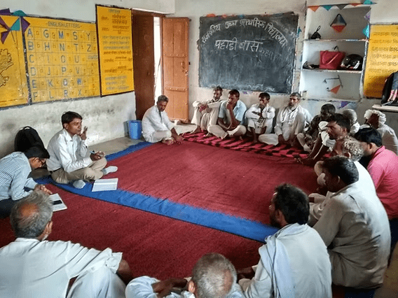 Parents, teachers, and School Management Committee members meeting in an Indian school, highlighting community involvement under Samagra Shiksha.
